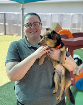 a woman holding a dog