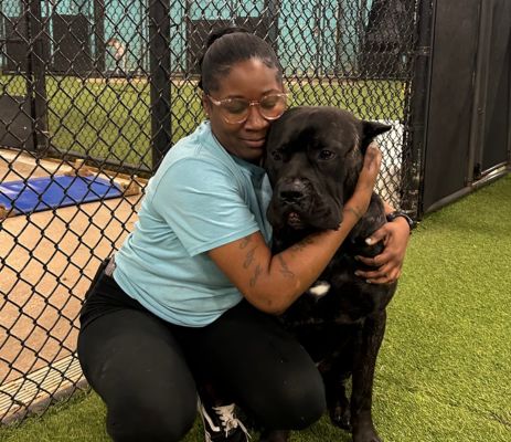 a woman hugging a dog