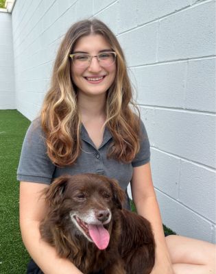 a woman holding a dog