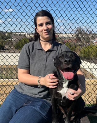 a woman sitting on a bench with a dog