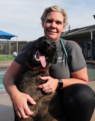 a woman holding a dog