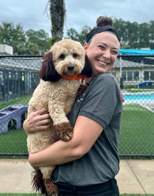 a woman holding a dog