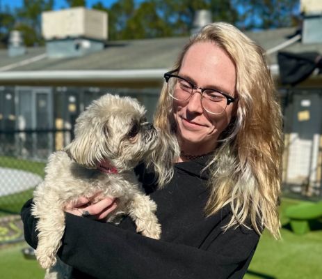 a woman holding a dog