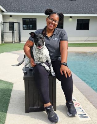 a woman sitting on a box with a dog