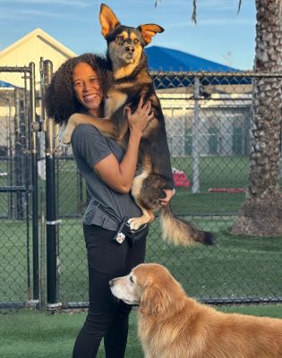 a woman holding a dog