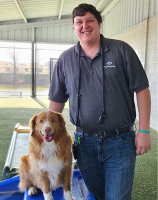 a man standing next to a dog