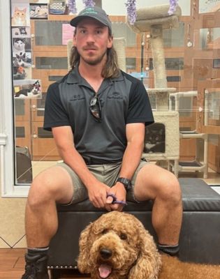 a man sitting on a couch with a dog