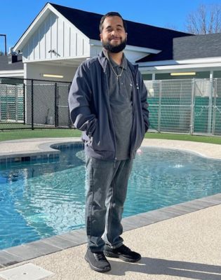 a man standing in front of a pool