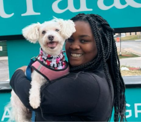 a woman holding a dog