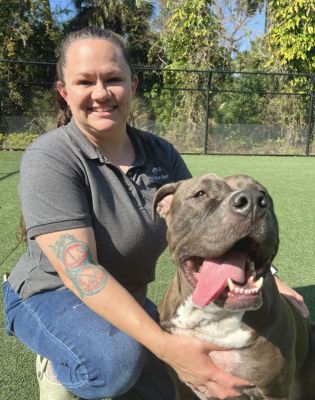 a woman holding a dog