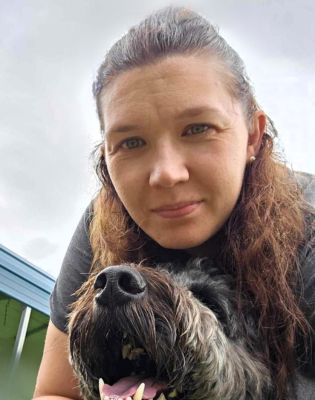 a woman taking a selfie with a dog